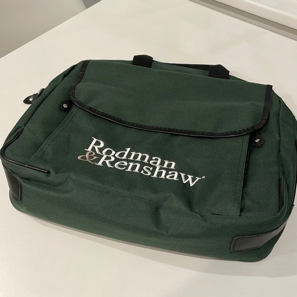 Dark green canvas briefcase with laptop sleeve and multiple pockets. NWT